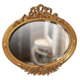 Antique French gold leaf oval beveled mirror.