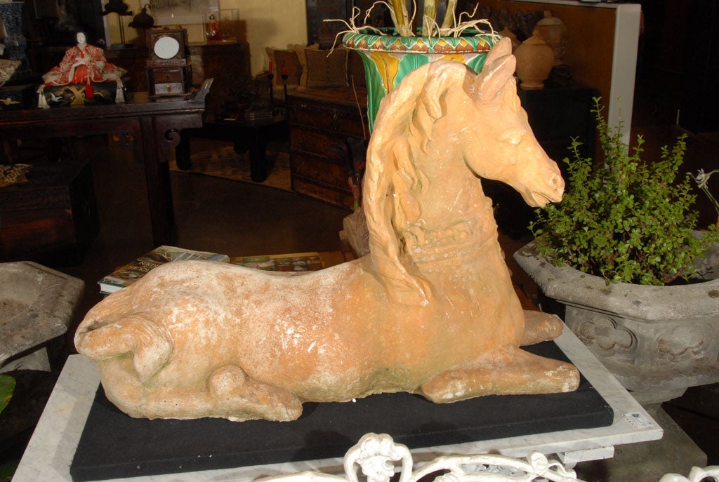 An English recumbent or reclining horse of garden stone featuring a terra cotta glaze, graceful design of the head and neck with flowing mane. 

A pair is available (priced individually: $2895 each).

Perfect for a Garden Room or Conservatory!