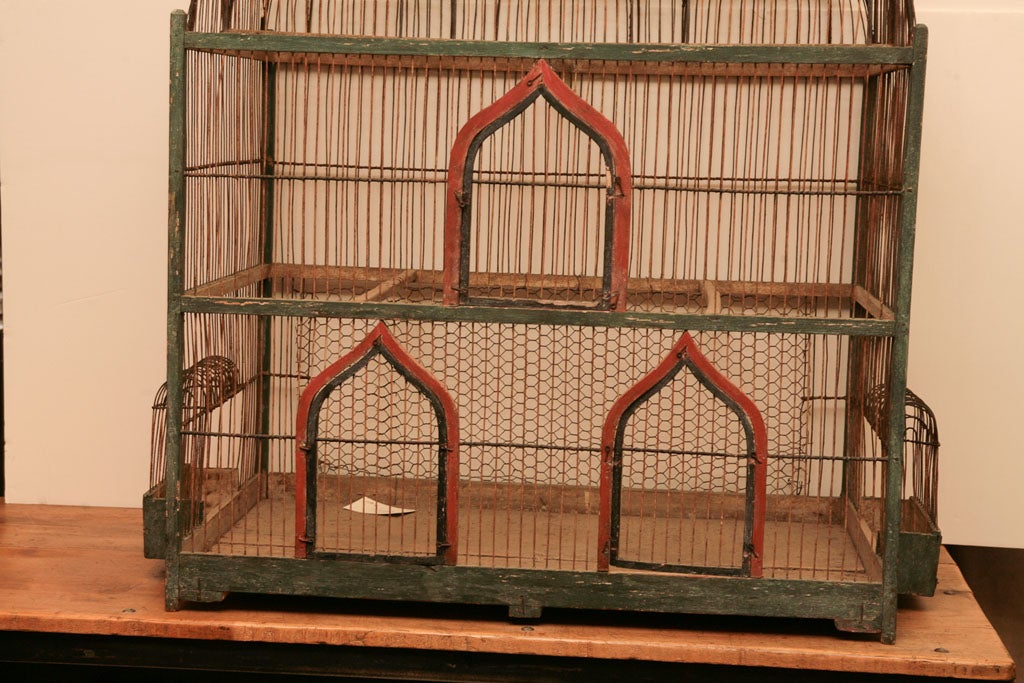 Very large green and red wood architectural birdcage