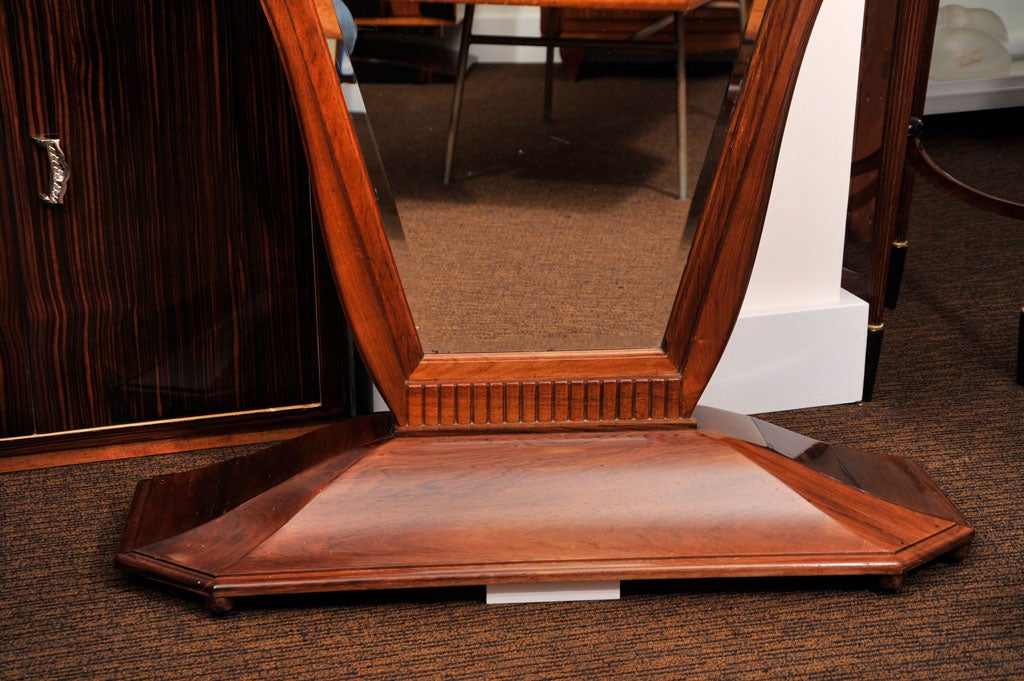 A French Art Deco rosewood cheval mirror attributed to Maurice Dufrêne.
