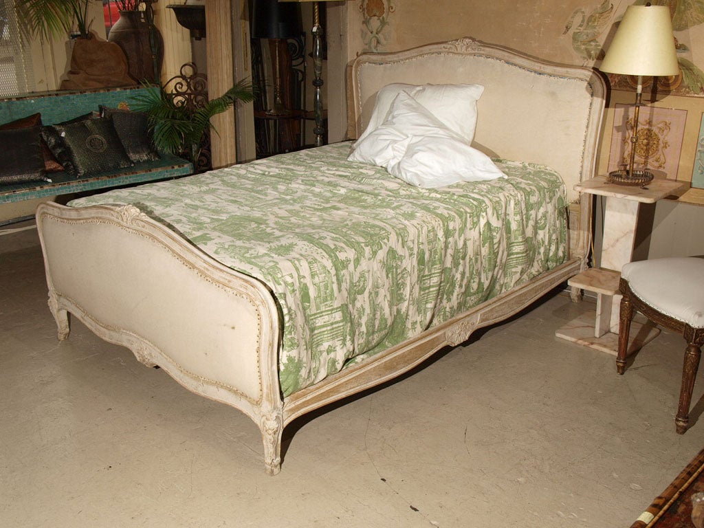 19th century bed with a wonderful whitewashed finish.  Nice carving. <br />
Fits queen or full sizes. We have original rails for full size and new rails to fit queen size mattresses.