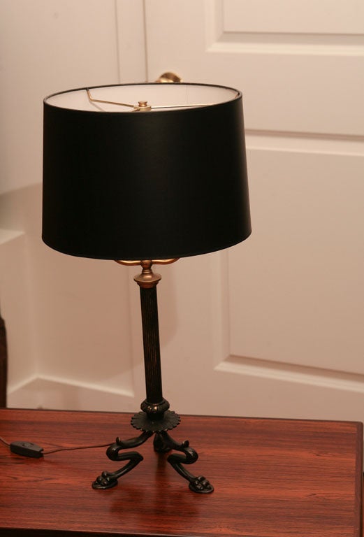 French brass and painted metal table lamp with tripod paw footed base.  Newly rewired.
