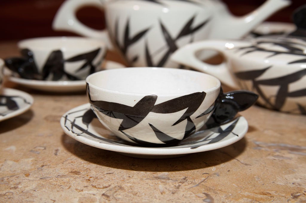 White ceramic with a black wheat motif, and black butterfly style handles.
France, circa 1930.

Raoul LACHENAL - Art Deco Ceramic Tea Set containing:
6 teacups: H: 1