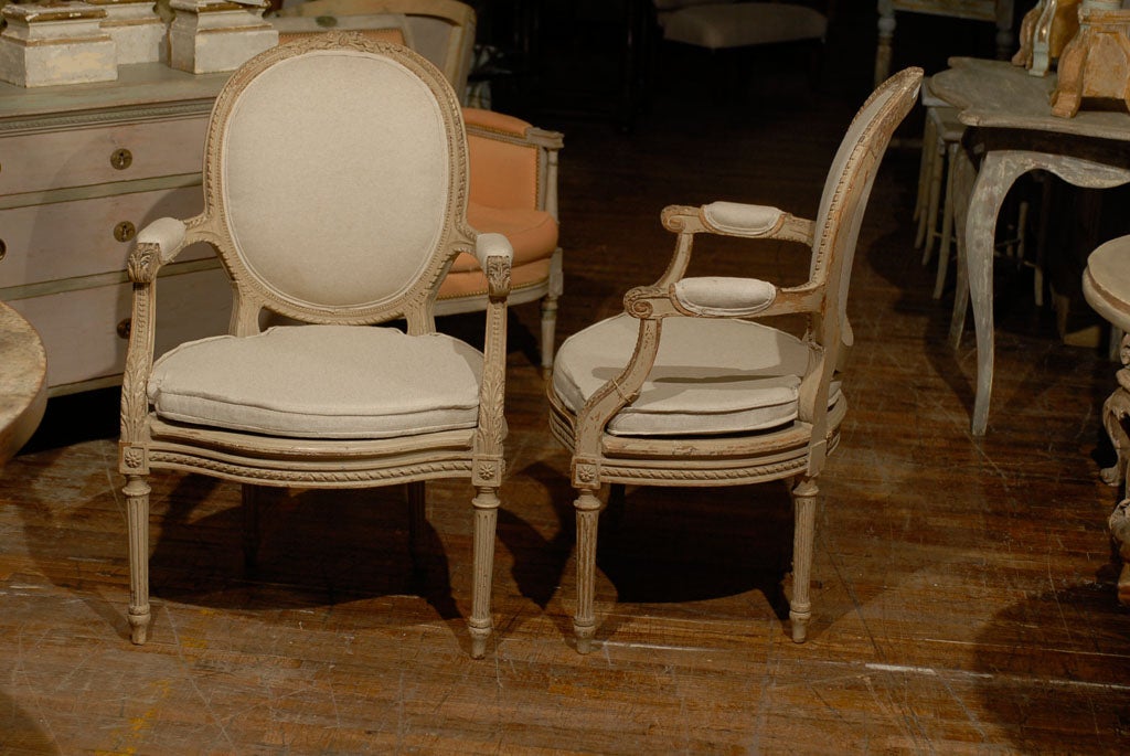 Early 20th Century Exquisite Pair of French Oval Back Painted Wood Upholstered Bergeres Chairs