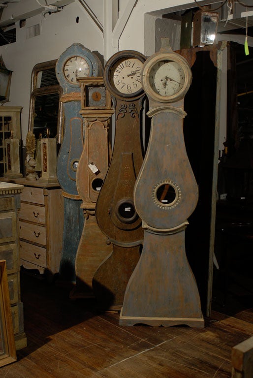 This undulating Swedish clock from the 19th century stands at 90” (7.5 feet) and is certain to enhance any room in which it’s placed. Its light blue / gray color with light wood tone coming through will compliment a wide spectrum of room colors.
