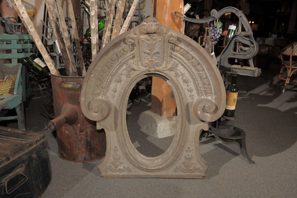 Decorative and detailed cast iron oval window frame.   Window opening 12