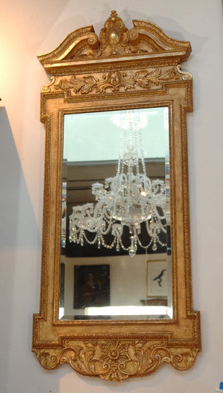 a George II carved giltwood mirror with swan neck pediment