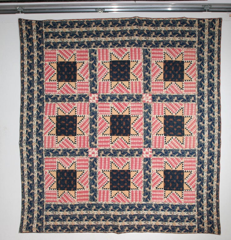 Unusual graphic rendition of traditional pattern in rare period fabrics.  Border is a striped floral print with exceptional colors of indigo and green.  Backing is an extraordinary coppery seaweed print.  Fabrics in the quilt were most likely