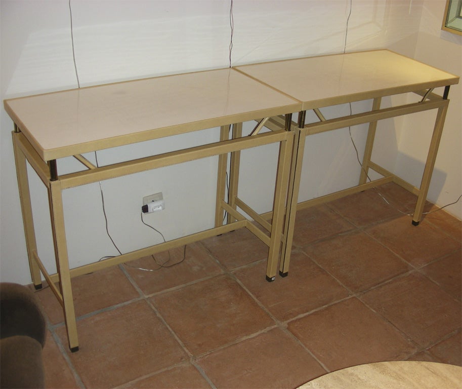 Two 1950s console tables with two heights possible for top surface (highest 78 cm.), by Jacques Adnet. Top in the original white formica; new leather. Price indicated is for the two, but it is possible to acquire only one.