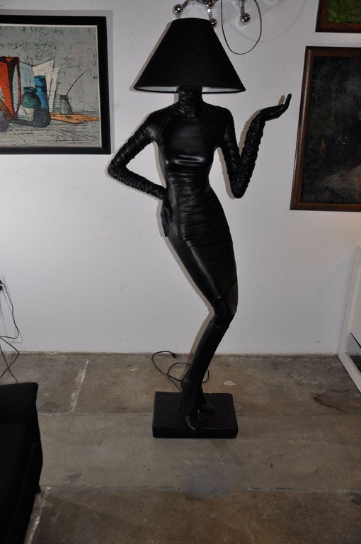 An elegant and sexy floor lamp made of resin, reflecting Bauhaus minimalism with a Grace Jones persona merging in a regeneration of styles compatible with today's and tomorrow's classy furniture.