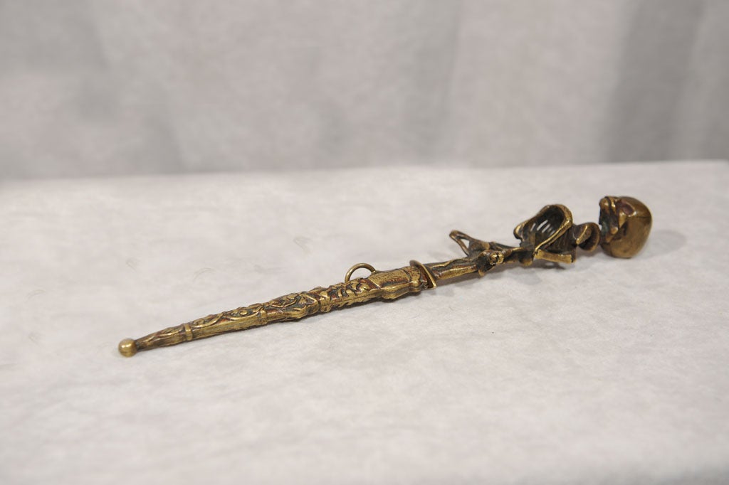 Here's one to scare the wife and kids.  This bronze dagger has all the goodies: the skull, the snake, and a beautiful, sharp blade.  This has been well cared for, as the blade is still sharp enough to fend off your enemies.  A great collector's item