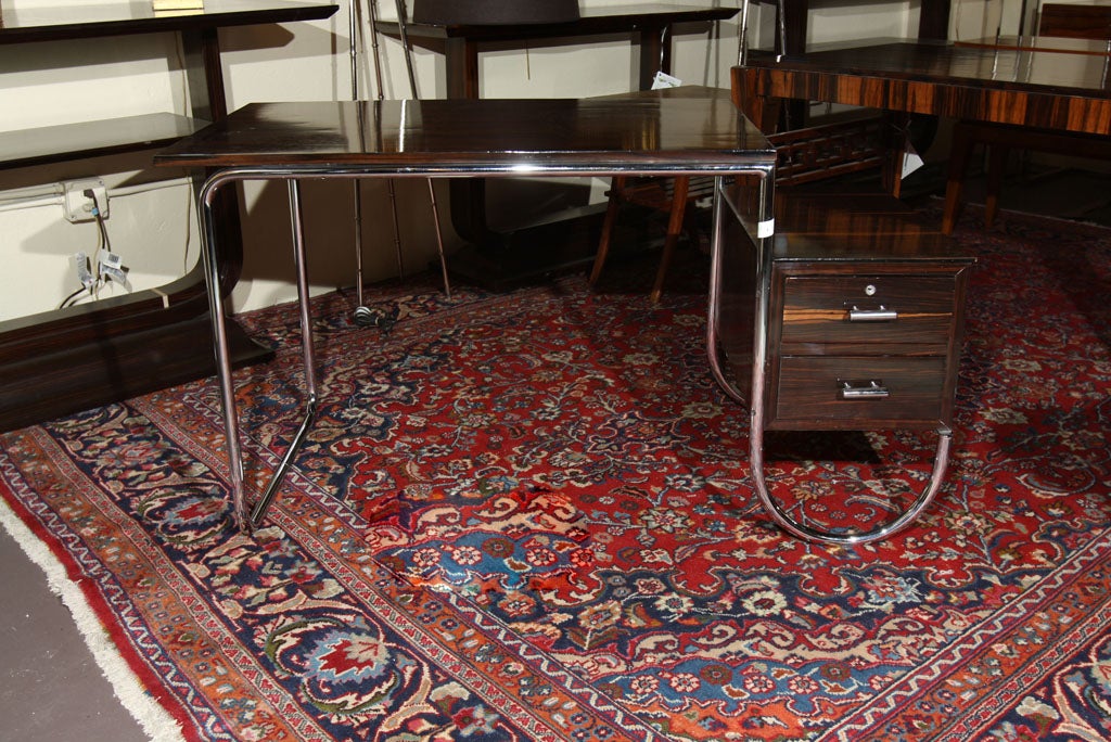 An intriguing art deco style desk with Macassar ebony top and drawers with chrome base.