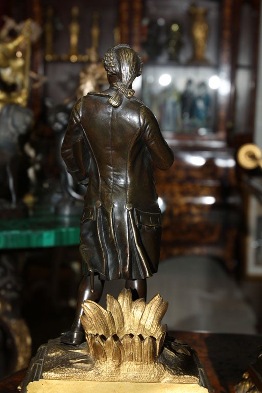 18th Century and Earlier A   Pair of Patinated Bronze Figures of a Male and Female For Sale