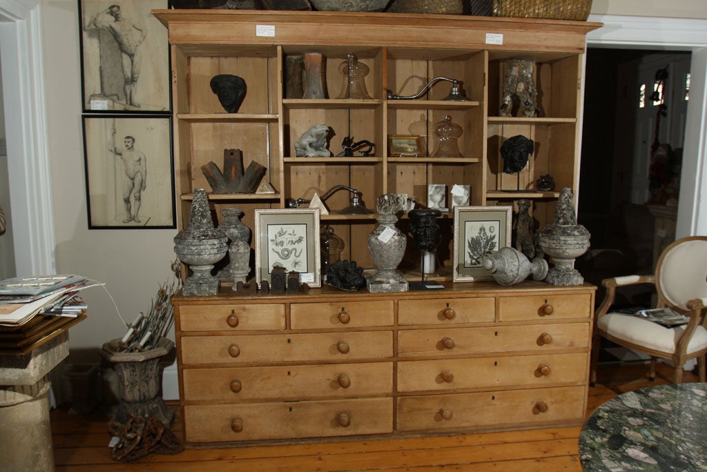 This authentic scrubbed pine cabinet in 3 parts is wonderfully utilitarian and features 10 commodious drawers, 14 large cubbies and 4 upper doors (not shown) that conceal whatever priceless pieces or clutter you put behind them. With all original