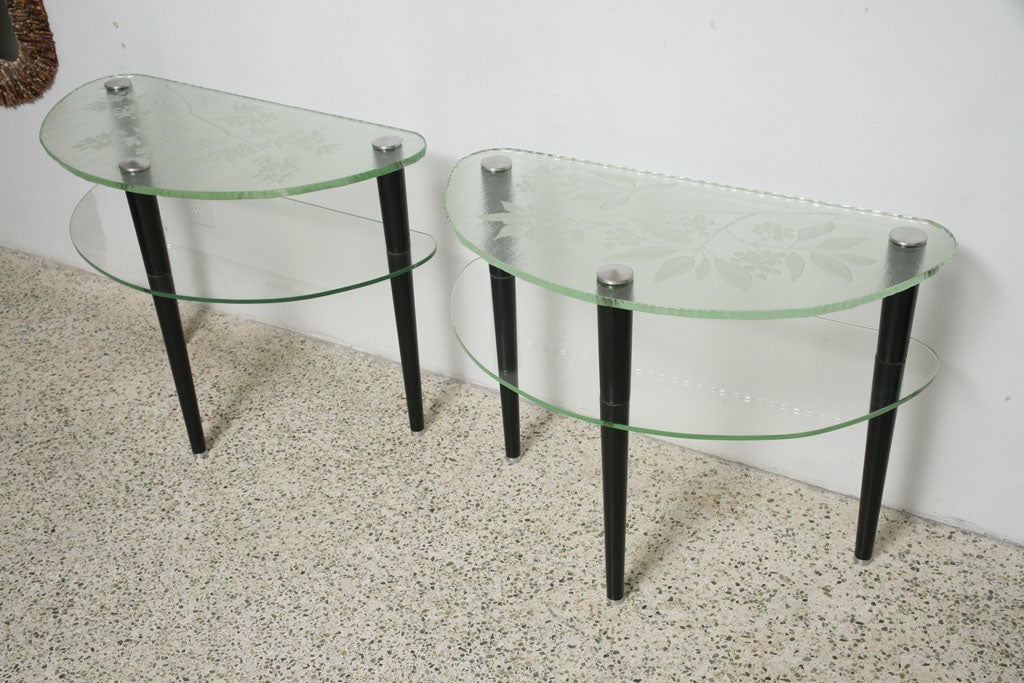 Pair of sofa Demi Lune tables. Acid etched ,sand blasted and cut Glass.<br />
Lacquered wood legs with steel fittings.Signed 