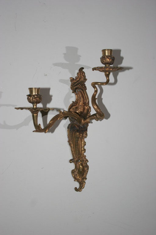 Wall Sconces Gilt Bronze French Rococo Louis XV 18th Century France. A pair of wall sconces made during the louis XV period in France. Two candleholding arms - can be wired if wanted. 

