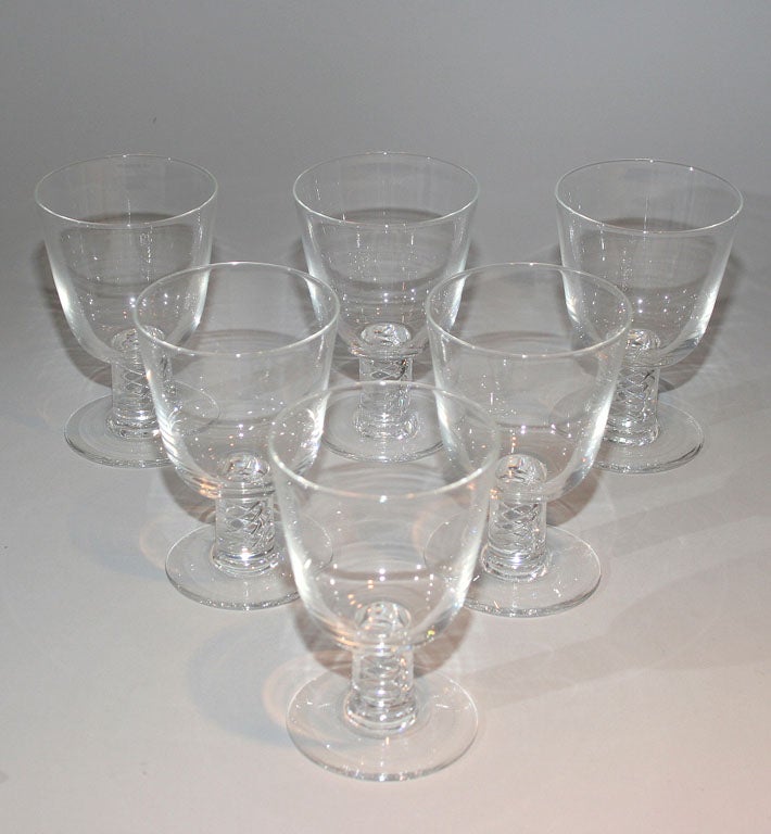 Set of six large goblets by Walter Dorwin Teague for Steuben, from the collection of Eliot Elisofon. Thick cylindrical stems feature helical pattern of air bubbles.