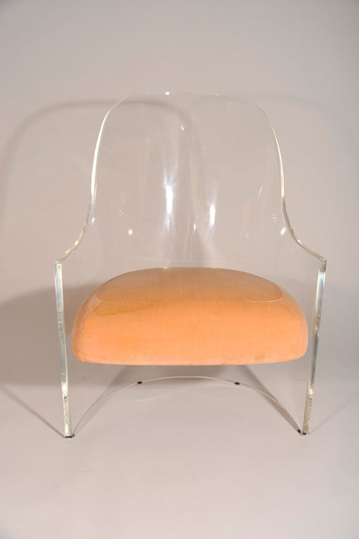 An elegant mod slipper chair in Plexiglas with a spoon back tub form, low arm rests, and a floating upholstered seat. By Vladimir Kagan. American, circa 1970. <br />
Seat height: 17