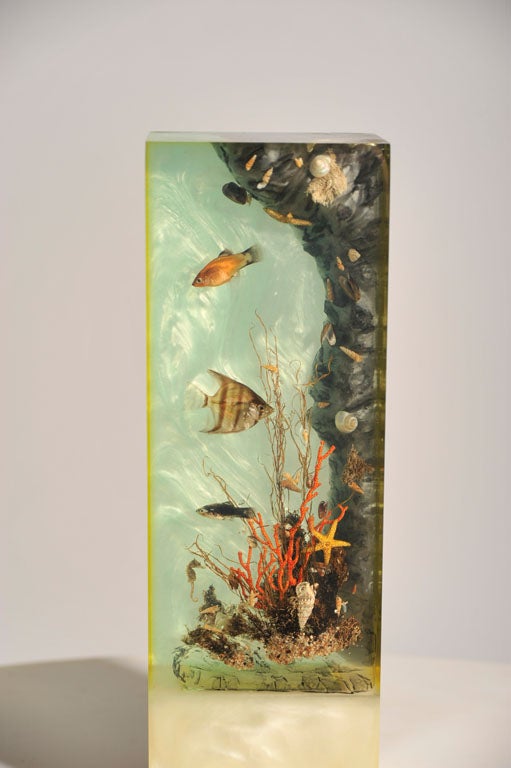 A vintage sculpture in cast Lucite with an “under-the-sea” motif, contains real fish suspended within layers of Lucite, a light from the bottom illuminates the sculpture. Italian, circa 1950.