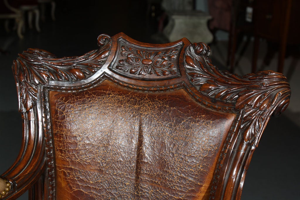 A fine carved rosewood desk chair, perhaps Anglo-Indian, upholstered in old leather.
