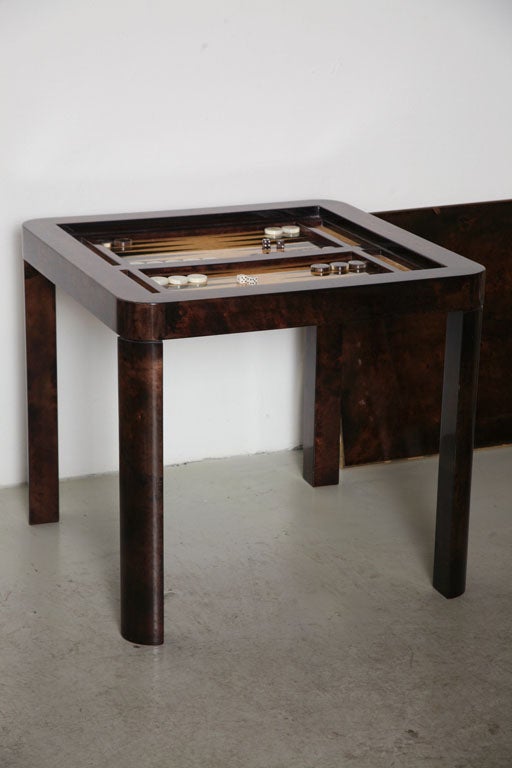 Rich brown goatskin covers the entire table, including the removable top surface, which reverses to brown baize for card playing. The backgammon well is in brown goatskin and vellum, retaining all its original playing pieces. Please note: Item