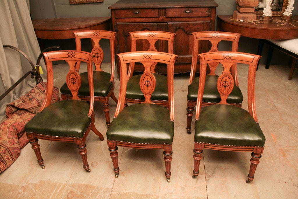 6 inlay cherry wood biedermeier chairs covered with green leather covered seats.