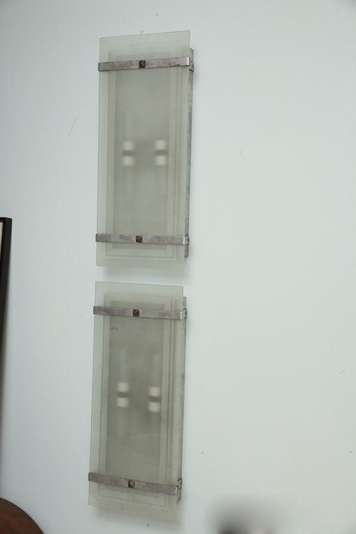 The rectangular frosted glass with banding over a nickel body with nickel straps and fasteners.