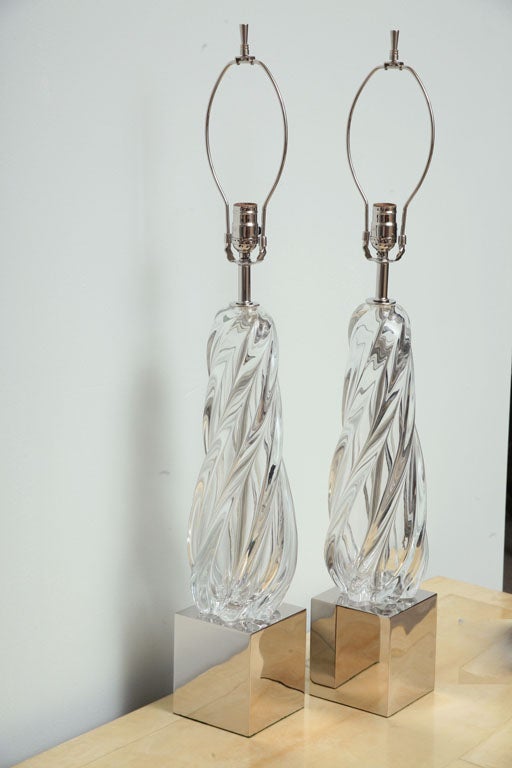 The swirling glass body on nickel-plated bases.