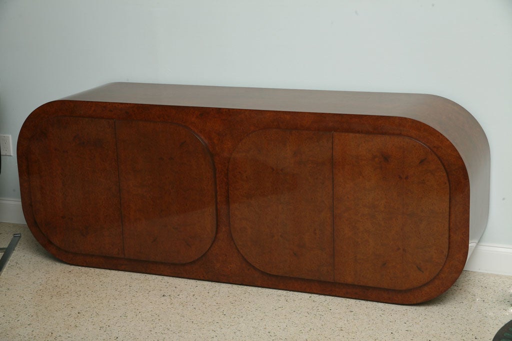 the overall body in rich burled walnut revealing shelved interior