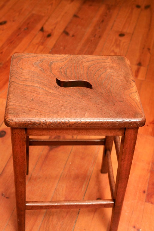 This stool came from an English pub in the south of England. The opening was used to move the stool around in the pub. this particular stool is perfect for counter height and the patina is stunning. it is also quite sturdy and because of its shape,