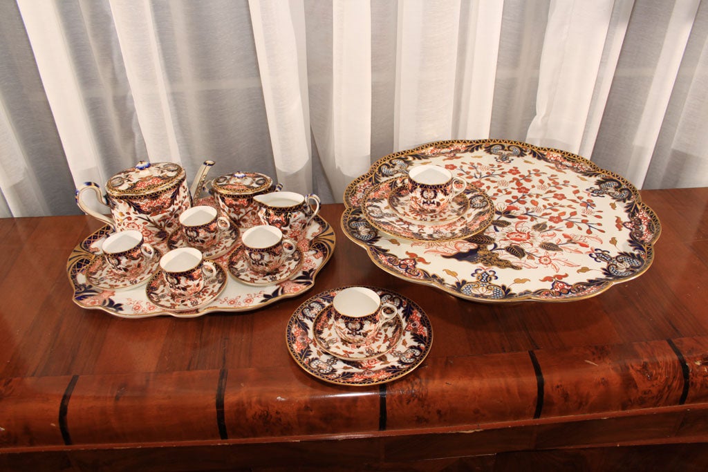 19 piece Imari pattern tea set. 3 piece tea set, 6 tea cups, 6 saucers, 2 plates, 1 platter, 1 cake plate on rotating stand. Smaller platter is 20th century. Dimensions are for large cake platter.