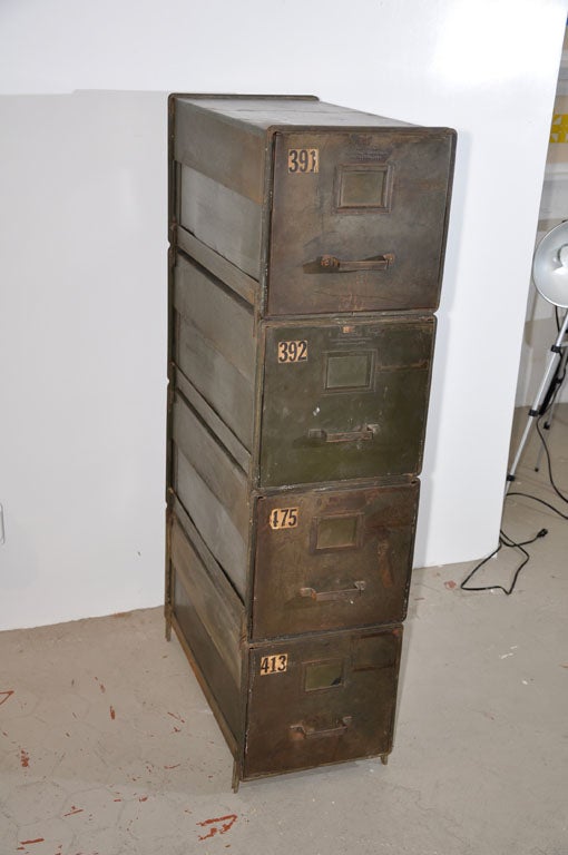 Unique vintage stacking metal file cabinets in army green. Units are very versatile and can be stacked individually on a desk or up to four high. Metal side bars enable sturdy stacking and all drawers fit standard files. Each drawer has an original