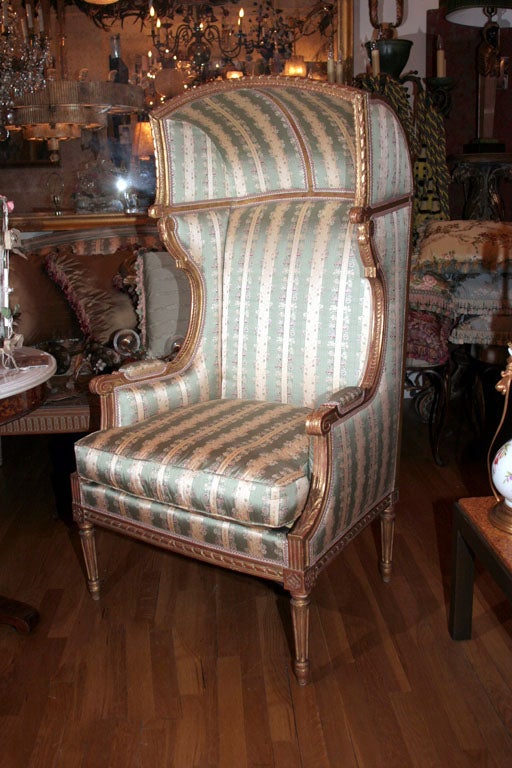 A French Louis XVI porters chair with carved and giltwood frame having leaf tip acanthus leaf etc. details overall and with half dome canopy over full upholstered back and sides with upholstered hand rest. Provenance: Whitney Estate 