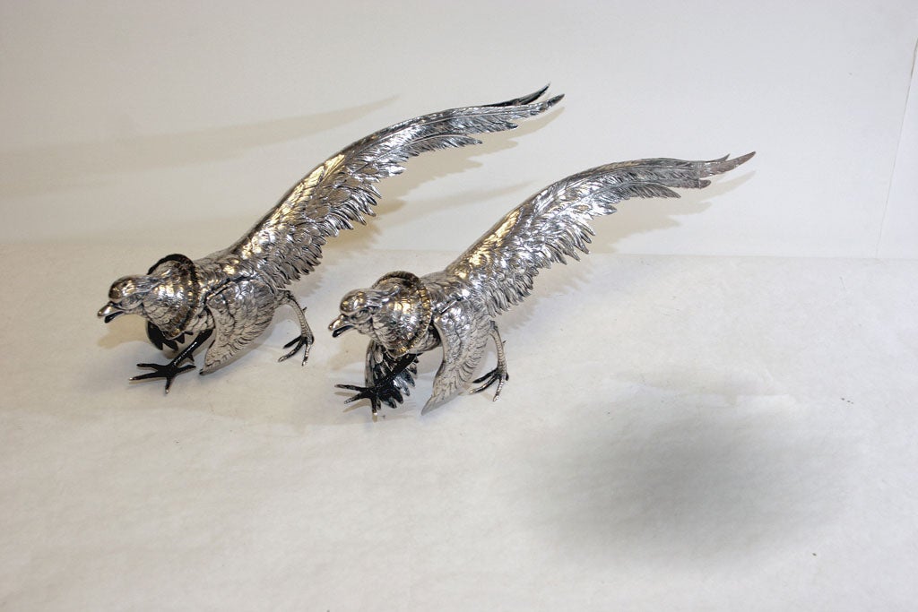 EACH REALISTICALLY MODELLED, WITH HINGED WINGS AND DETACHABLE HEADS. INDISTINCTLY STAMPED WITH SILVER MARKS. WEIGHT: 44oz