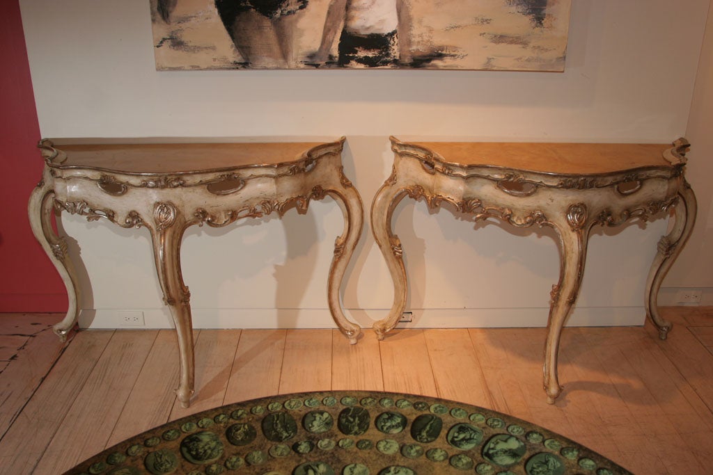 A Pair of Serpentine White Painted and Parcel Gilt Consoles