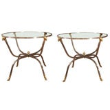 Pair of circular steel side tables with brass ram's head and hoo