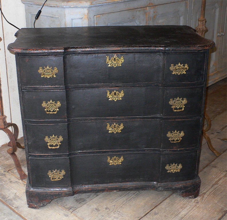 1810s Dutch commode in black patina wood with four drawers and gilt bronze handles.