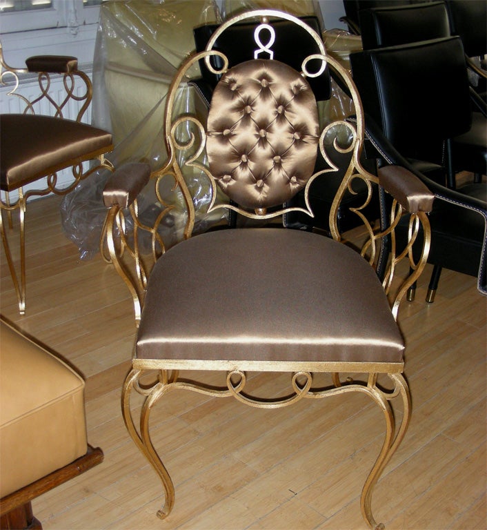 Two 1940s armchairs by René Prou in wrought iron, re-gilt and re-upholstered.