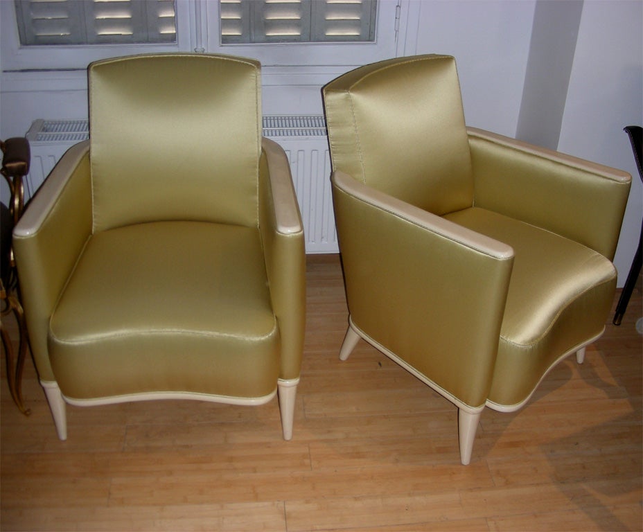 Two 1940s armchairs by René Prou in ivory lacquered wood, re-upholstered in yellow satin.