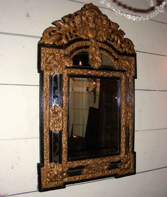 Napoleon III bevelled mirror with patinated repoussé copper and black wood frame.