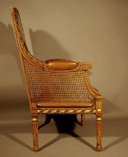 . 1870s
. Louis XVI style armchair
. Structure in carved walnut
. Leather upholstery and double caning
. Gilded wood part