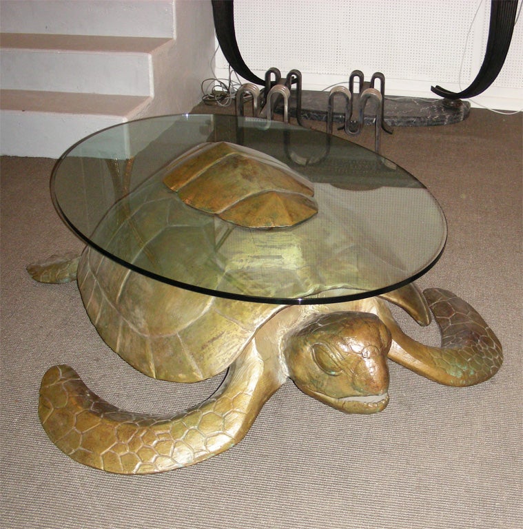 1970s turtle coffee table in gilt bronze, with top surface in glass.