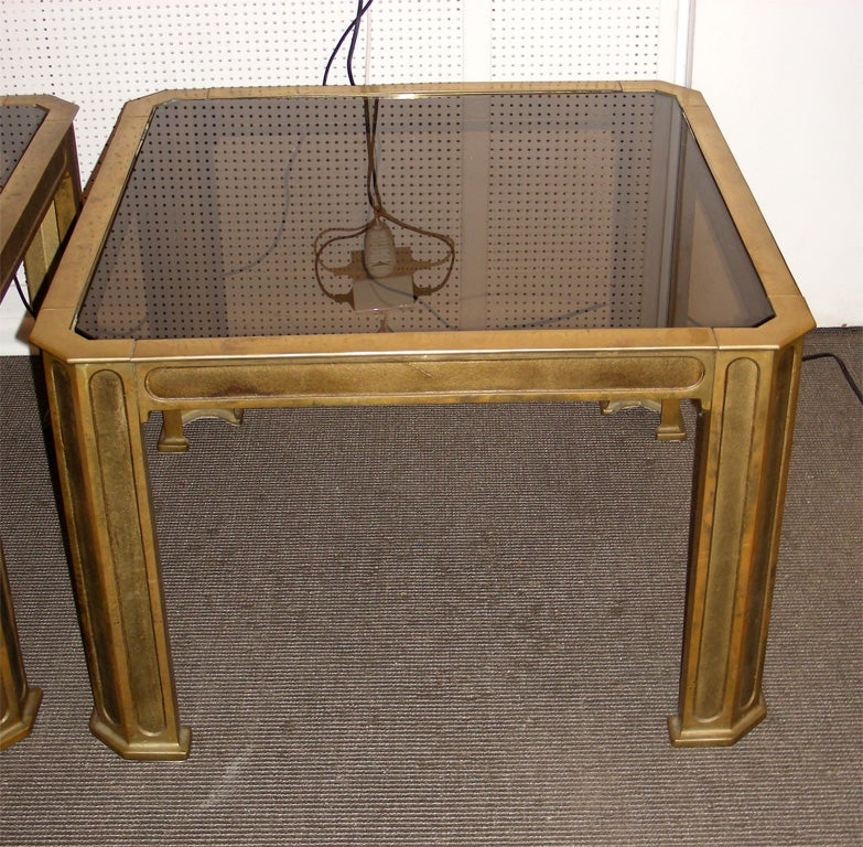 Two 1970s end tables by Van Heeck in gilt bronze with smoked glass top.