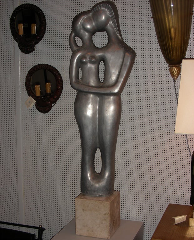 1970s sculpture in cast aluminum of an embracing couple signed by L. Joubert, set on a marble base.
