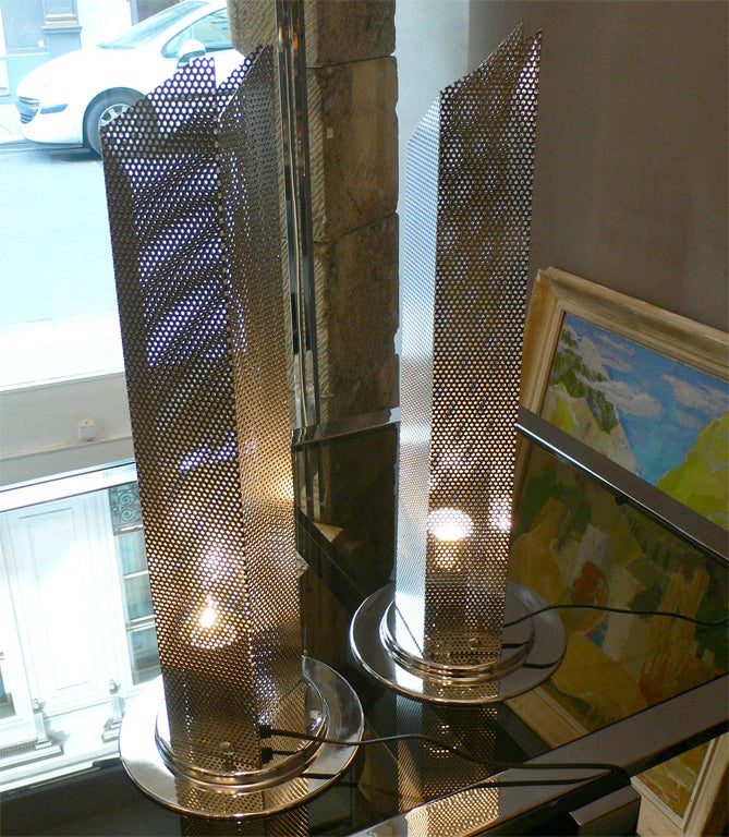 Two 1980s lamps in perforated metal on the shaft and chromed metal round base.
