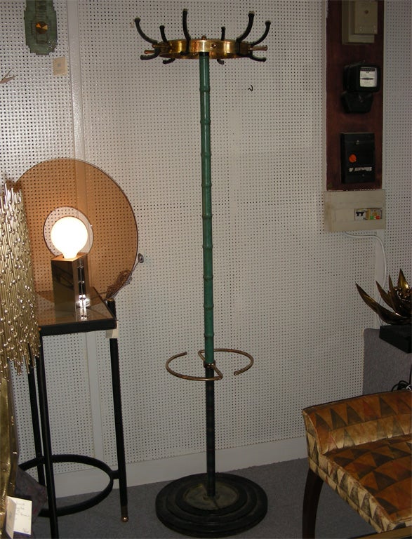 1950s coat stand by Jacques Adnet in stitched leather, brass and metal.