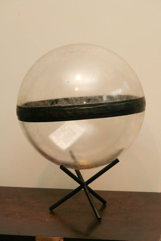 Deep sea glass measuring sphere made by Benthos, Inc. Falmouth, Mass.<br />
Used to measure sea depth.  Now an interesting table object.