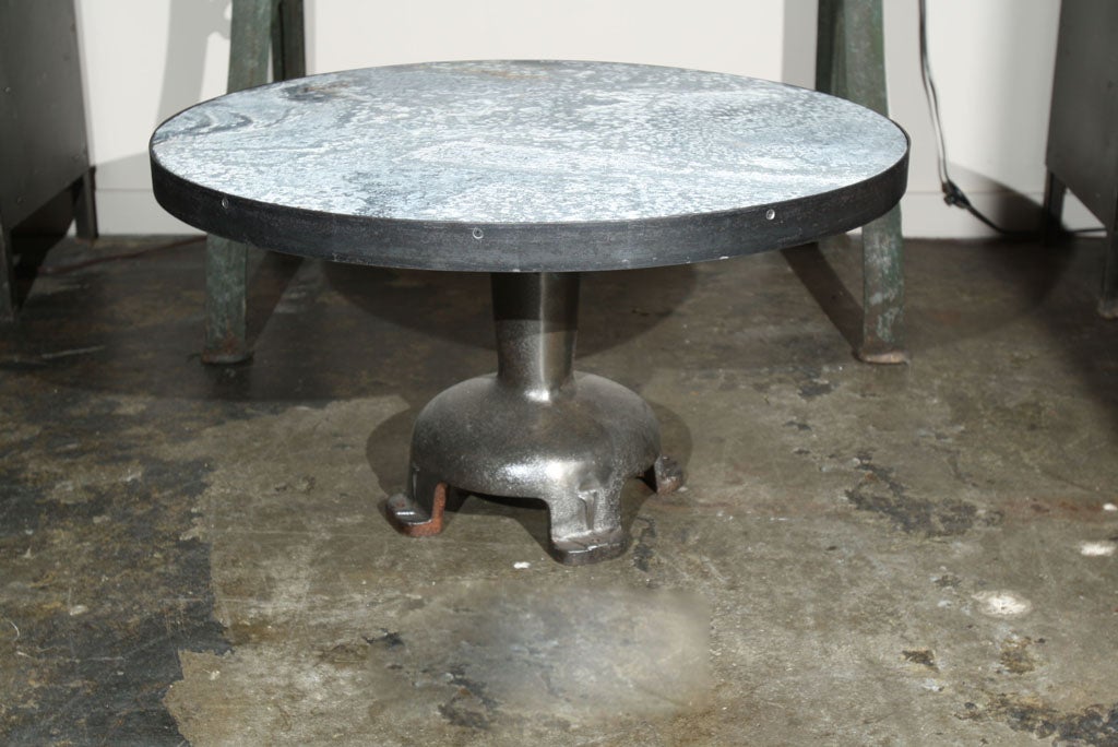 round zinc top with steel banding on vintage cast iron industrial base