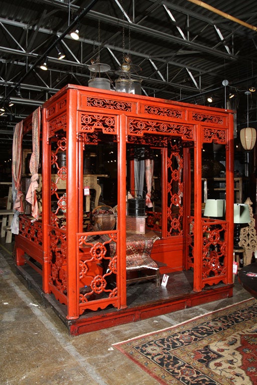 red lacquered platform bed with vestibule.
