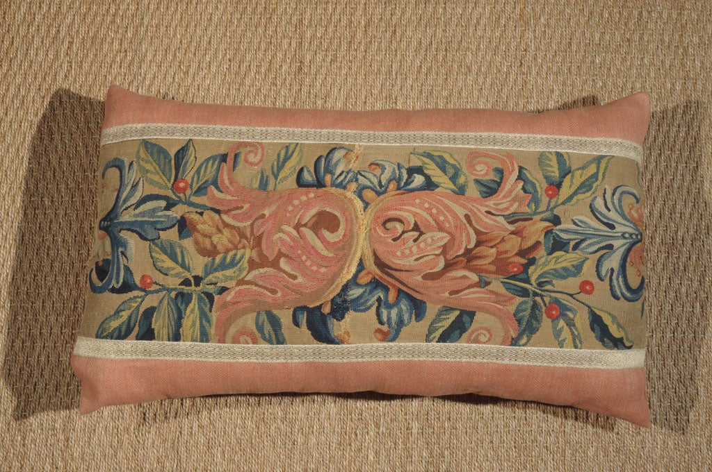 The colors and over all design of this Italian tapestry are exceptionally distinctive. The pink “tulip looking” flowers mixed in with numerous shades of green leaves, pops of red from the berries and curvy blue details make this pillow highly
